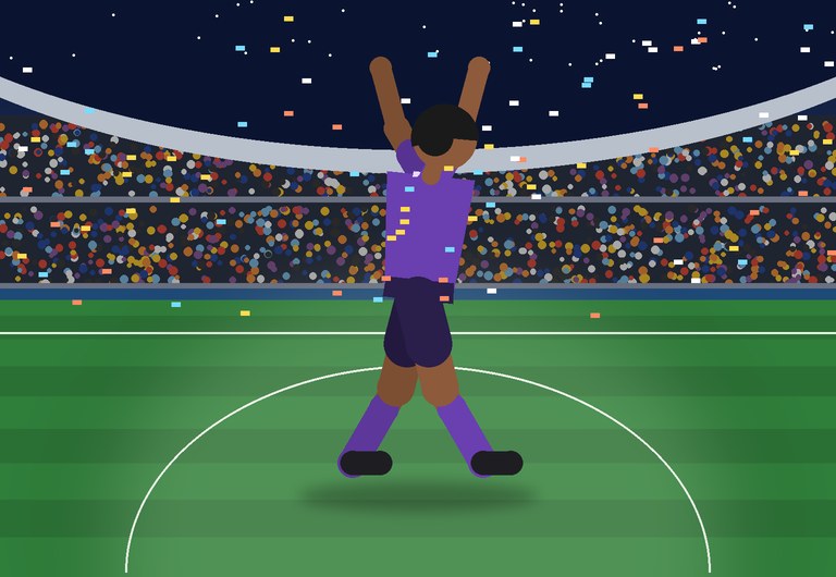 A player celebrates a goal at night